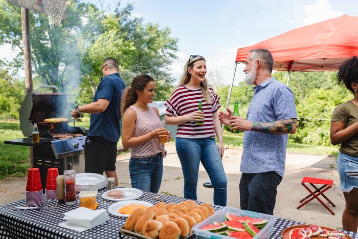 Friends celebrating and eating at a tailgate party