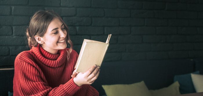 The girl is reading a book in a cafe